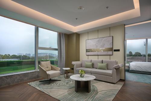 a living room with a couch and a bed at Holiday Inn Wuhan Tianhe Airport by IHG in Wuhan