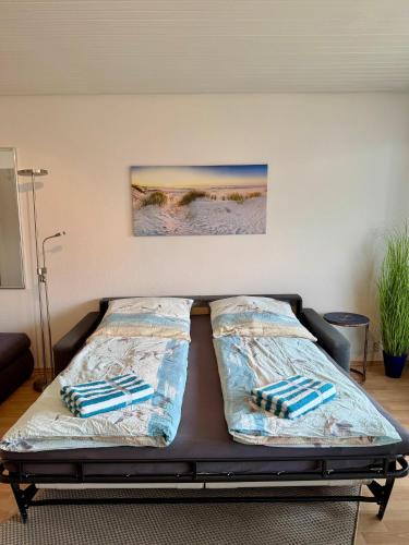 a bed in a room with two pillows on it at Poseidon 1 6 in Wangerooge