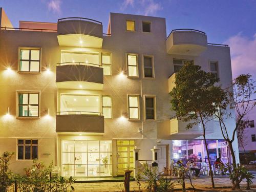 a building with a lit up facade at night at Planktons Beach in Hulhumale