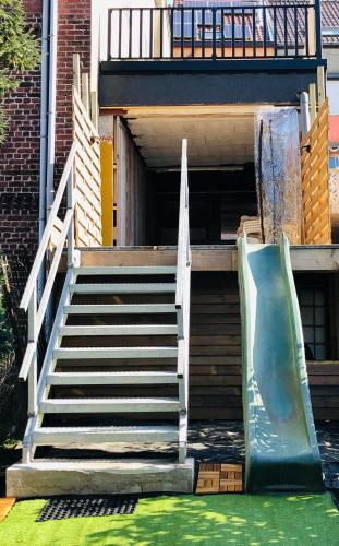 a staircase with a slide in front of a building at Vakantiewoning De Passerelle in Geraardsbergen