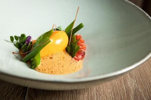 a plate of food with a desert on a table at Am Pfarrhof - Gourmethotel by Harald Irka in Sankt Andrä-Höch
