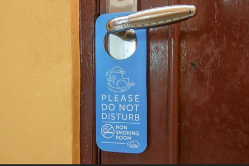 a sign on a door that says please do not disturb at Ambon Residence Syariah in Ambon