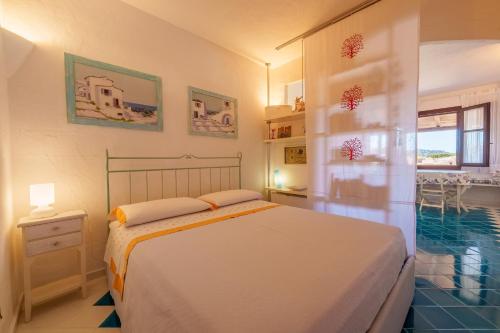 a bedroom with a bed and a swimming pool at Residence La Virginia in Palau