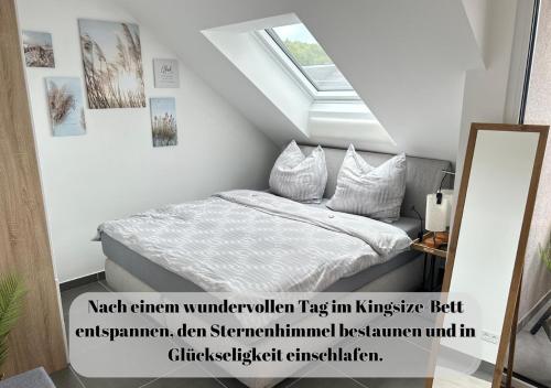 a bedroom with a bed in a attic at Ferienwohnungen Im Kimmelreich in Irsch