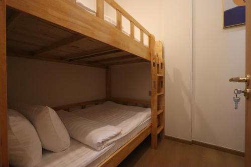 a bunk bed with white pillows in a room at Casabella Homestay 202 Batam Penuin in Nagoya