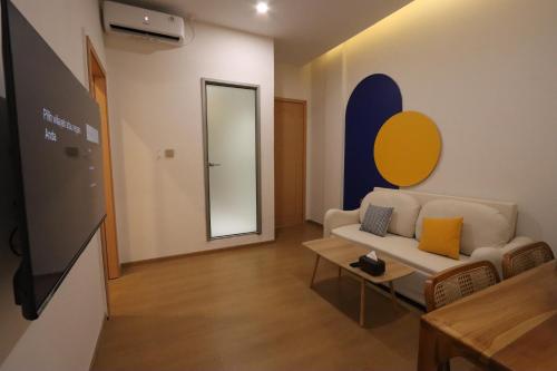 a living room with a couch and a tv at Casabella Homestay 202 Batam Penuin in Nagoya