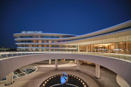 an external view of a building at night at Crowne Plaza Wuhan Tianhe Airport by IHG in Wuhan