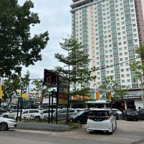 a white car parked in a parking lot with buildings at Casabella Homestay 207 Batam Penuin in Nagoya