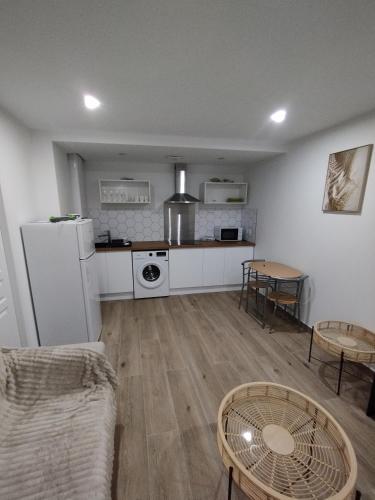 Il comprend un salon avec un réfrigérateur blanc et une cuisine. dans l'établissement Studio Cosy et Calme, à Boé