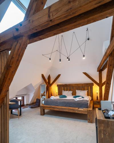 a bedroom with a bed and wooden beams at Wanderer Sighisoara in Sighişoara