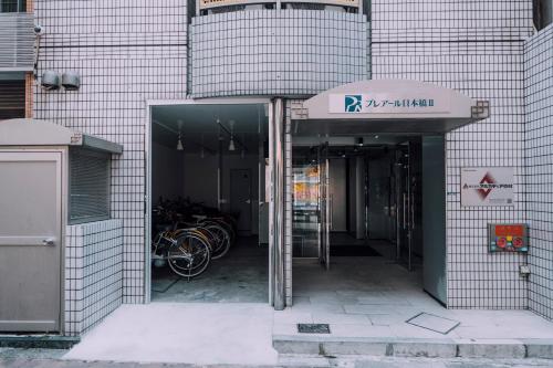 an entrance to a building with bikes parked in it at Minimalist Loft Namba Compact Studio with a 24-hour Gym MA502 in Osaka