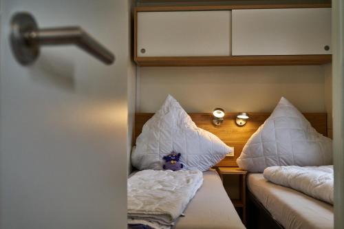 a room with two beds with white pillows on them at AlbCamping Westerheim in Westerheim
