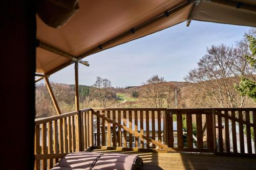 a room with a bed on a wooden balcony at AlbCamping Westerheim in Westerheim