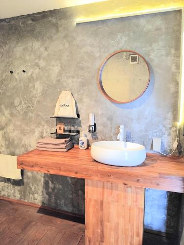 a bathroom with a sink and a basketball hoop on the wall at Stäy Hotel in Nago