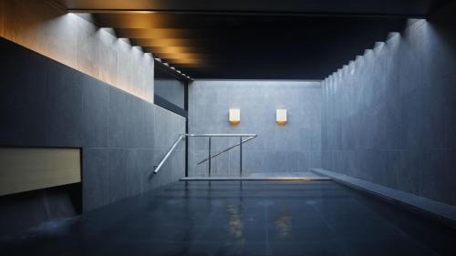 a room with a swimming pool with two lights on the wall at SOKI ATAMI - Vacation STAY 01473v in Atami