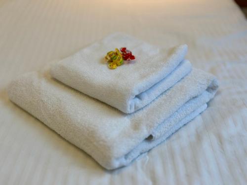 a pile of towels sitting on top of a bed at Citadel 2 - Powered By NEO - Free Parking in Timişoara