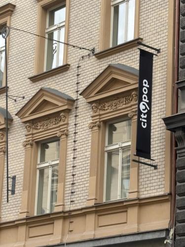 a building with a sign on the side of it at City Pop Prague Aparthotel in Prague