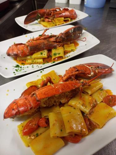 three plates of food with different types of seafood at Locanda Al Santuario in Peschiera del Garda