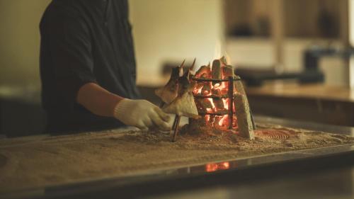 a person is preparing food on a counter at SOKI ATAMI - Vacation STAY 01416v in Atami