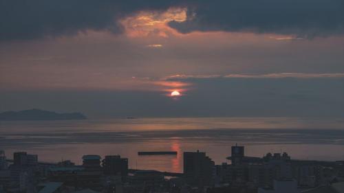 a view of the sun setting over a city at SOKI ATAMI - Vacation STAY 01416v in Atami