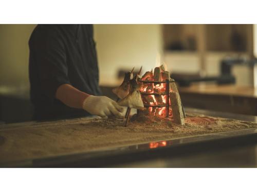 a person preparing food on top of a counter at SOKI ATAMI - Vacation STAY 93411v in Atami