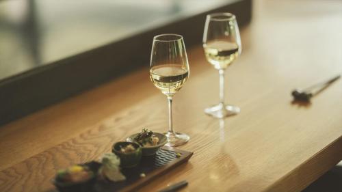 two glasses of white wine on a wooden table at SOKI ATAMI - Vacation STAY 01407v in Atami