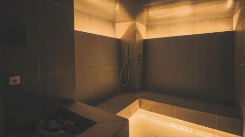 a dark bathroom with a shower with a tub at SOKI ATAMI - Vacation STAY 01407v in Atami