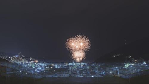 a firework in the sky over a city at night at SOKI ATAMI - Vacation STAY 01407v in Atami