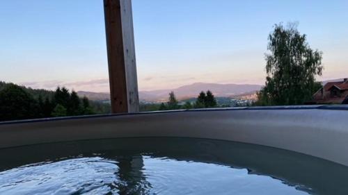 a swimming pool with a view of the mountains at Rabenstein Suiten in Zwiesel