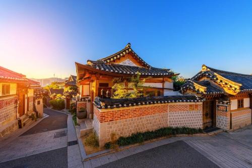 an asian style building with a brick wall at Zen Seoul Stay in Seoul