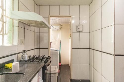 a kitchen with a sink and a stove top oven at AP familiar com parquinho perto do centro in Pelotas