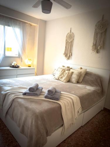 a bedroom with a bed with towels on it at Apartamento 21 calle jardin in Calpe
