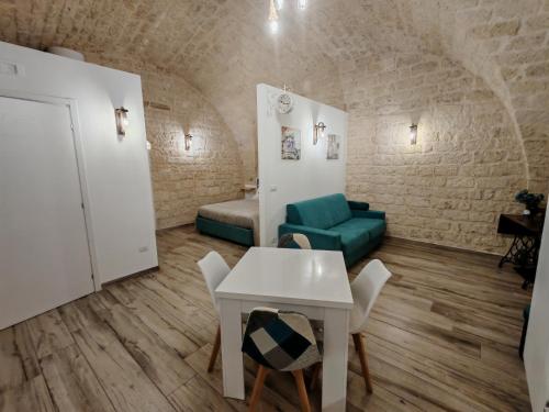 a living room with a table and a couch at SaLò Apartments in Manfredonia