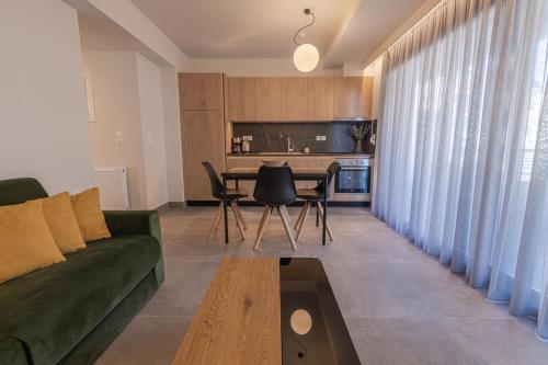 a living room with a green couch and a table at Aeson Premium Living in Volos