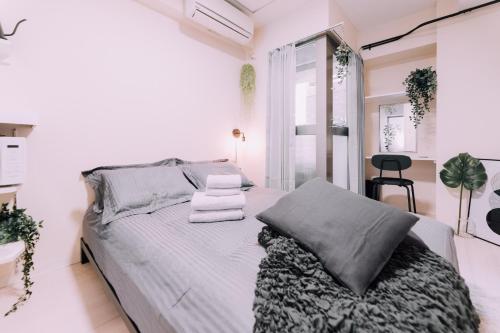a white bedroom with a bed and a window at Minimalist Loft Namba Compact Studio with a 24-hour Gym MA1001 in Osaka