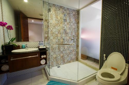 a bathroom with a shower and a toilet and a sink at Ubud Wana Resort in Ubud