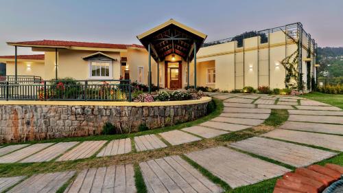 a house with a stone walkway in front of a building at SaffronStays Coonoor Canvas in Coonoor