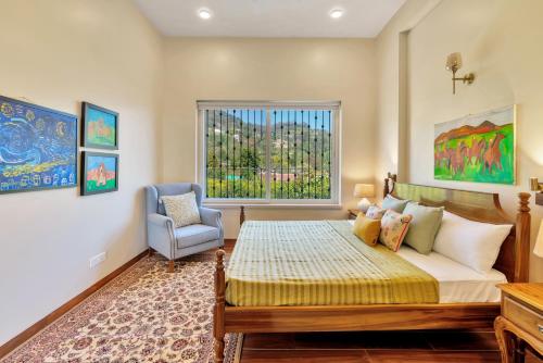 a bedroom with a bed and a chair and a window at SaffronStays Coonoor Canvas in Coonoor