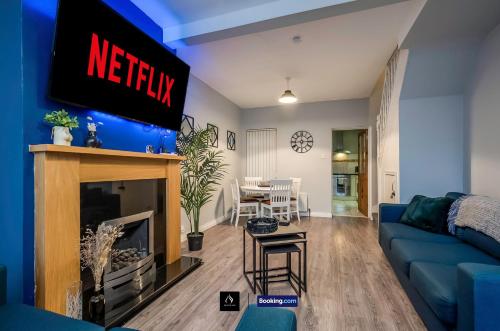 a living room with a tv above a fireplace at 2 Bedrooms House By Boyeilles Apartments Short Lets & Serviced Accommodation Belfast With Free Wifi in Belfast