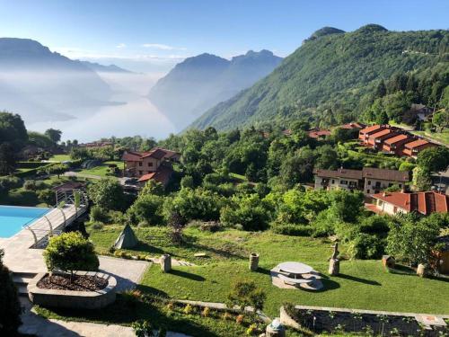 a resort with a view of the mountains at Bellagio Lake View apartment Rosabella with swimming-pool in Civenna