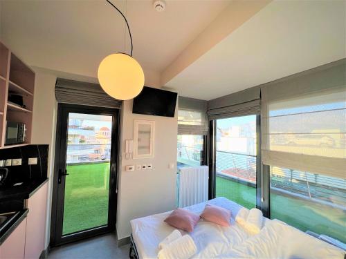 a bedroom with a bed and a large window at Aeson Premium Living in Volos