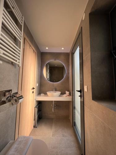 a bathroom with a sink and a mirror at Aeson Premium Living in Volos