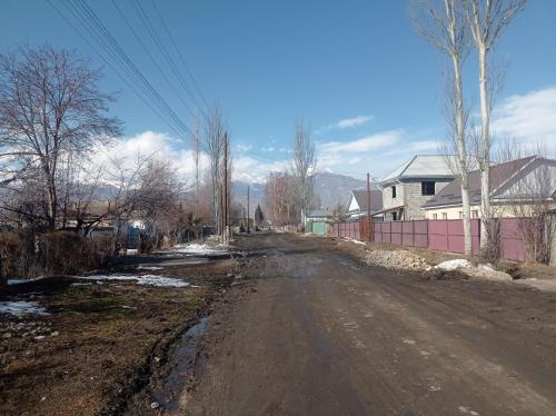 uma estrada de terra vazia com uma casa ao lado em Гостевой дом em Sazanovskoye