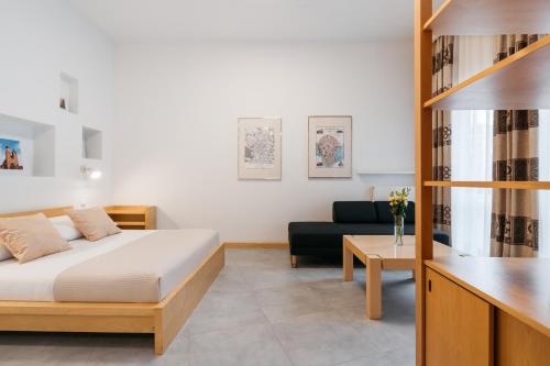 a bedroom with a bed and a living room at Native Apartments Krupnicza 7 in Kraków