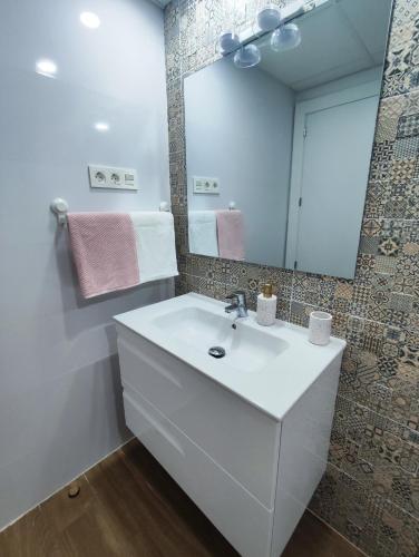 a bathroom with a white sink and a mirror at La casa de Ángel - CASCO HISTÓRICO! in Cartagena