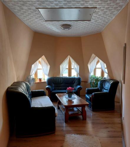 a living room with two couches and a coffee table at Diána Fogadó in Keszthely