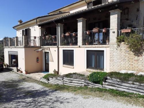 a white building with a balcony with plants on it at VILLETTA TRA GLI ULIVi 2 in Citta' Sant'Angelo