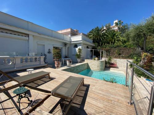 une arrière-cour avec une terrasse en bois et une piscine dans l'établissement Villa avec piscine, Nice Centre, à Nice