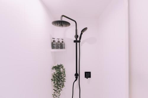 a black floor lamp in front of a door at Minimalist Loft Namba Compact Studio with a 24-hour Gym MA302 in Osaka
