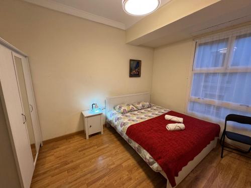 a bedroom with a bed with a red blanket and a window at L13 - 5 Bedrooms 2 Baths, Very Large Apartment by the Sea in Alicante